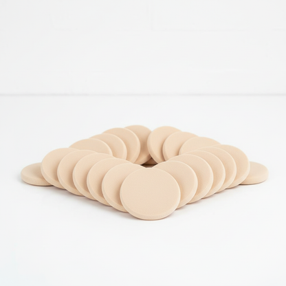 Crown disposable foundation sponges arranged on clean surface