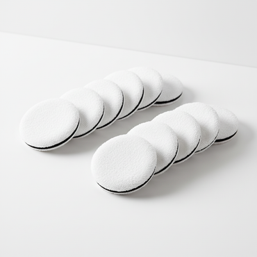 Crown disposable compact powder puffs arranged on clean surface